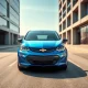 2027 Chevy Bolt EV on city street showing redesigned front end and new features