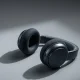 Apple AirPods Max 2 headphones in midnight color on a studio surface.