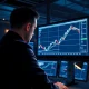 Financial analyst reviews AUD/USD bullish breakout forecast on trading screen.
