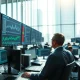 Financial analyst monitors market data following Pershing Square's IPO filing announcement.