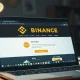 Laptop screen showing a fake cryptocurrency listing website as described in Binance CEO's warning.