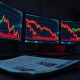 Breaking news on Bitcoin, Ethereum, and XRP price crash due to US-Iran war fears shown on trading desk monitors.