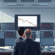 Financial trading desk showing BrightView Holdings stock chart with oversold RSI indicator