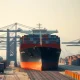 Container ship at Chinese port symbolizing export resilience amid Middle East geopolitical risks.