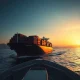 Cargo ship navigating Strait of Hormuz as cocoa shipping threats disrupt global supply chains in 2026