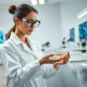 Scientist in biotech lab represents Coherus Oncology CHRS earnings report and oncology research.
