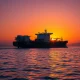 Oil tanker navigating Strait of Hormuz during crude prices rally despite IEA stockpile release
