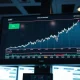 Financial trading screen showing U.S. dollar index chart rising amid market volatility.