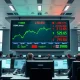 Dow Jones Industrial Average rises as oil prices plunge on trading floor display.