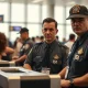 TSA officers at an airport security checkpoint as Elon Musk offers to pay salaries.