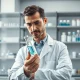 Scientist analyzing medication in lab representing Esperion Therapeutics' cardiovascular drug research and Q4 earnings report.