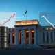 Federal Reserve building with economic pressure from weak jobs data and oil price shock