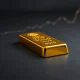 Gold bullion bar representing the surge in gold price above $5,200 per ounce.