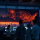 Professionals in a grid control room analyzing data on an underutilized electrical network map.