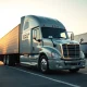 Heartland Express truck at dawn representing the company reaching its critical stock price target.