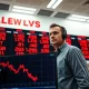 Trader monitors falling lean hog futures prices on exchange board during commodity market sell-off.