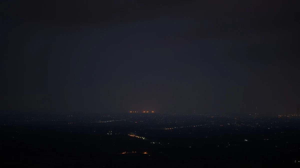 A distant view of a city skyline at night under a tense, cloudy sky, representing the region of reported strikes.