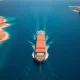Larry Kudlow Hormuz Strait analysis with aerial view of strategic oil shipping channel