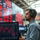 Trader monitors falling lean hog futures prices on exchange board during USDA market report.