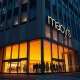 Exterior of a Macy's department store at dusk, reflecting its Q4 earnings report.