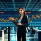 Financial analyst reviews unusual options trading activity for MSTR, CORZ, and DJT stocks on trading floor monitors.