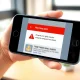 Meta scam detection tools warning alert on a smartphone screen for Facebook, WhatsApp, and Messenger security.