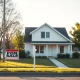A house for sale as mortgage rates reach 6%, symbolizing housing market pressures.