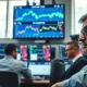 Traders monitor natural gas price charts on a financial trading floor.
