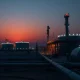 A natural gas processing facility under a dusk sky following attacks on Middle East energy infrastructure.