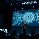 Nvidia CEO Jensen Huang on stage at GTC conference presenting AI strategy.