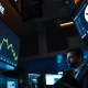 Stock trading floor showing Nvidia's declining share price on digital displays.