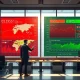 Financial analyst monitoring contrasting stock market and oil price data on digital dashboard during March 2026 market volatility