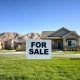 For Sale sign in front of a Reno Nevada home as California homebuyers seek affordability.