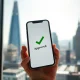 Revolut UK banking licence approval symbolized by a smartphone with an approved checkmark over London's financial district.