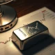 Silver bullion bar on a financial chart showing a price surge to $68.20.