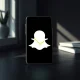Smartphone displaying Snapchat logo with oversold stock chart analysis for September 2024 market conditions.