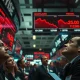 Stock market trading floor showing major indices plunging on fears of US-Iran war escalation.