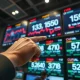 A trader monitors sugar and crude oil futures prices on a digital screen in a financial exchange.