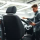 Toyota seat defect recall inspection in a dealership service bay for 550,000 vehicles.
