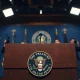 US Treasury Secretary Bessent's podium with seal at a press briefing on economic strategy.
