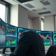 Trading desk monitors showing financial charts and data for stocks with unusual options activity.
