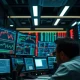 A trader's monitor displays complex stock charts and financial data feeds.
