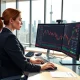 Trader analyzes USD/CAD chart showing Canadian dollar strength approaching 1.35 level on Toronto trading desk