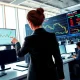 USD/CAD price analysis showing trader monitoring currency surge after IEA oil announcement.