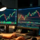 A trader monitors a USD/CHF forex chart on a financial terminal.