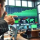 Trader in Tokyo analyzes surging USD/JPY and oil prices amid geopolitical tensions impacting the Japanese Yen.