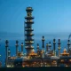Valero Energy oil refinery at dusk illustrating the industrial context of VLO stock performance.