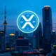 XRP cryptocurrency symbol over Tokyo skyline representing Japan's new payment platform launch and ETF growth.