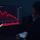 Analyst reviewing XRP price chart and ETF outflow data on a financial workstation.