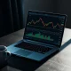 Analyst reviewing cryptocurrency market charts for XRP price analysis on a laptop.